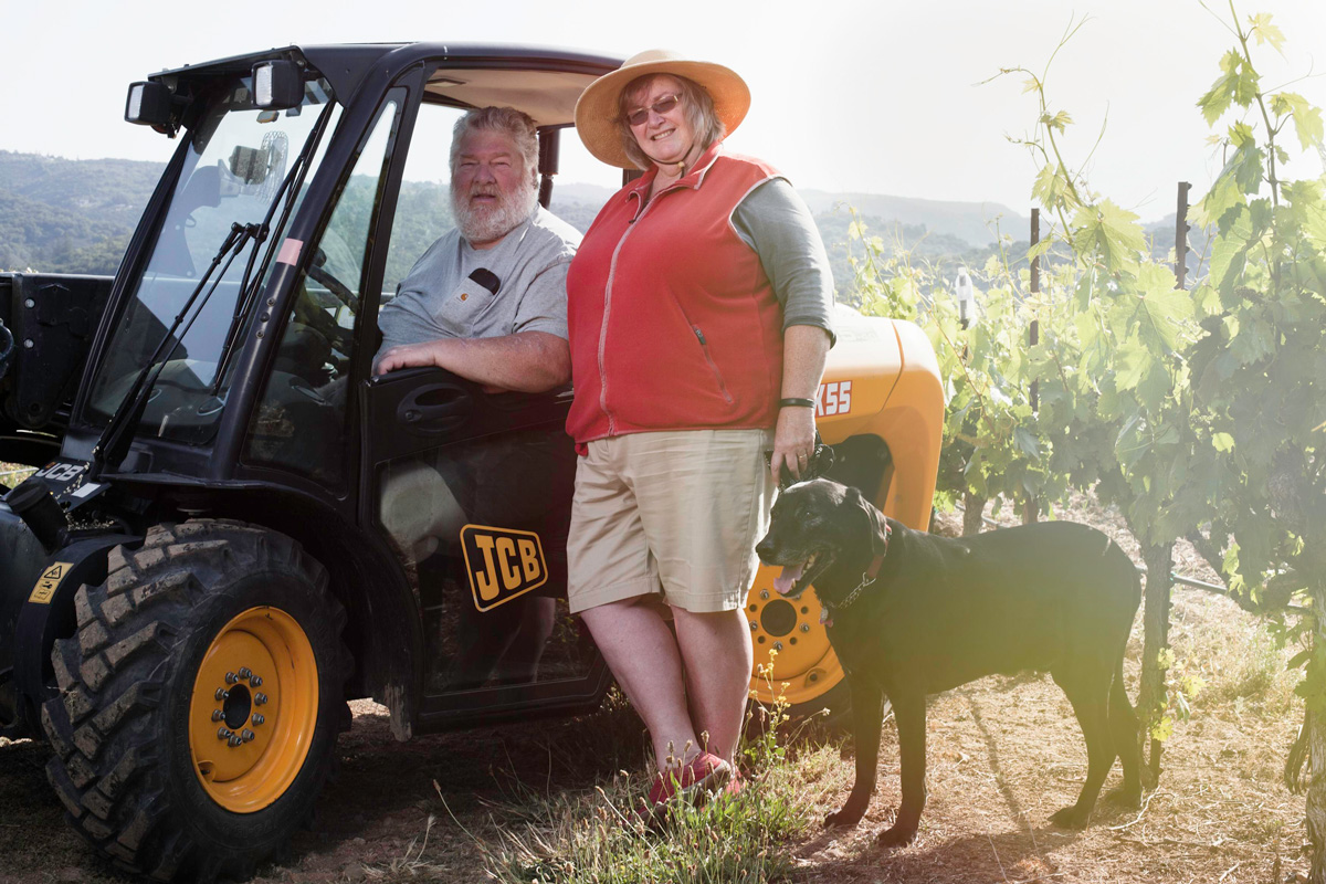 Robert and Diane Kenworthy in an ATV at Bedrock Vineyard
