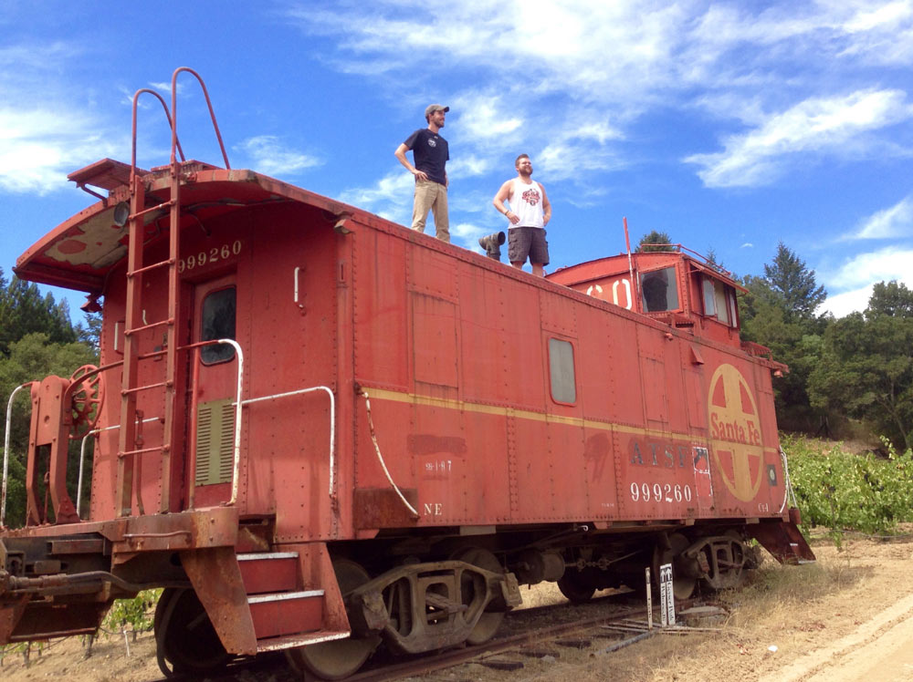 Luke and Cody standing atop the famous red caboose at the top of Nervo Ranch